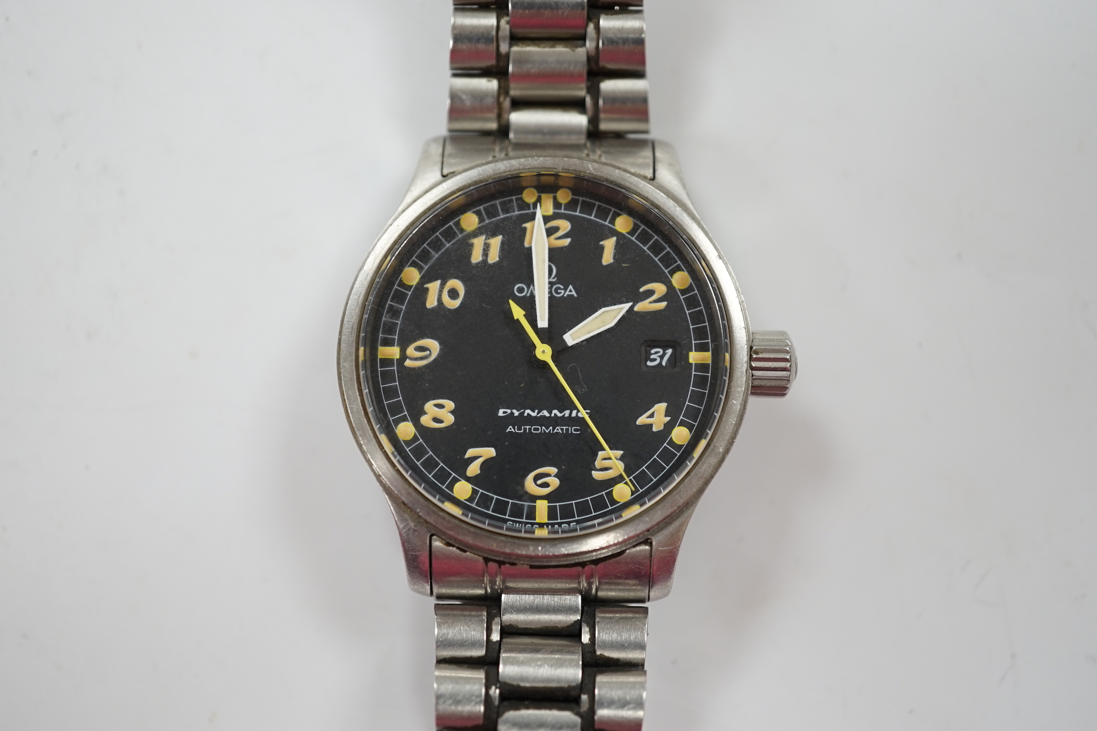 A gentleman's stainless steel Omega Dynamic automatic wrist watch, with black dial and date aperture, on a stainless steel bracelet, no box or papers, case diameter 37mm.